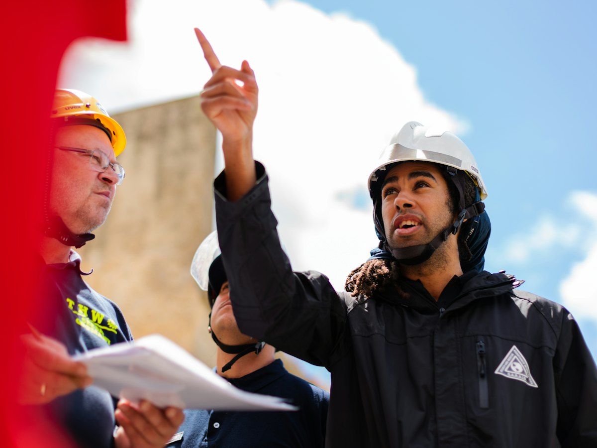 Engineers in safety helmets discussing work on site
