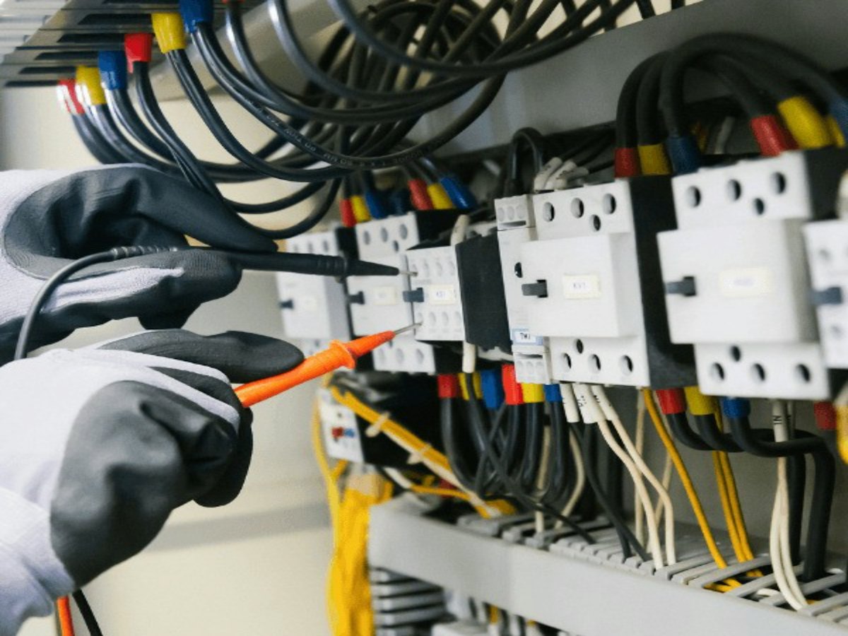 Gloved hand testing electrical contactors with a probe